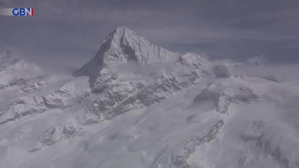 Train derails after being hit by avalanche in Switzerland as emergency services rush in to rescue around 80 passengers