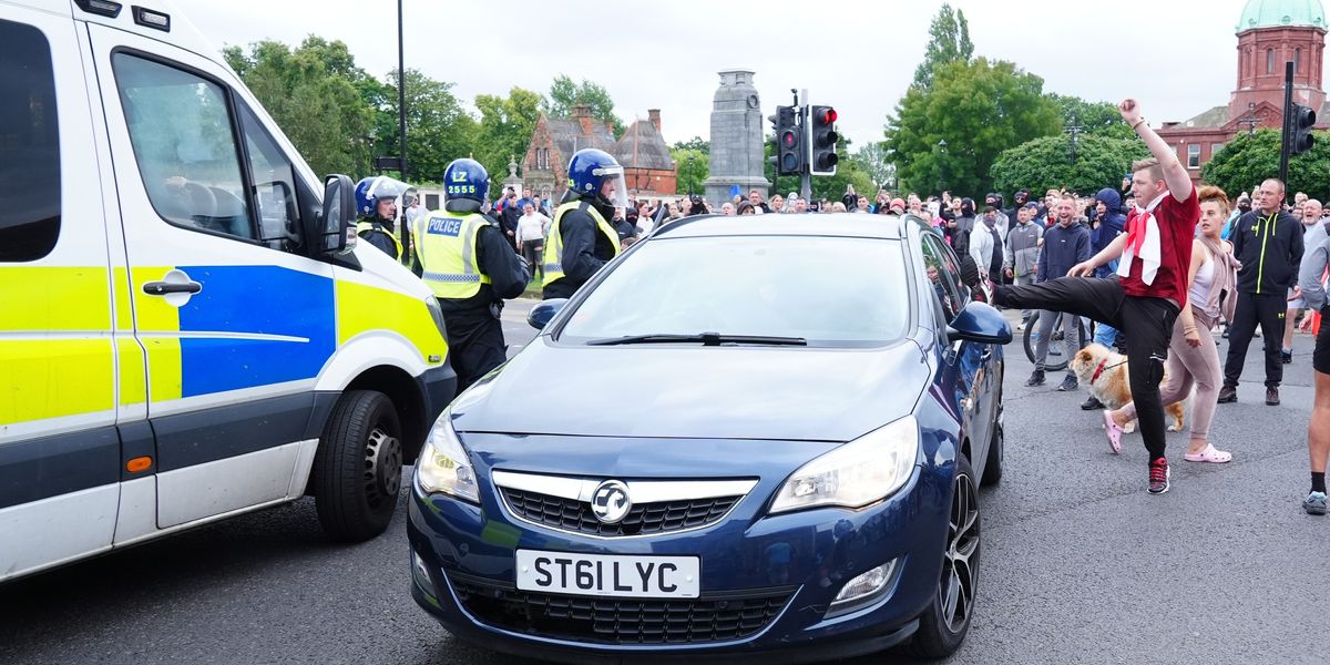NextImg:Rioter who used England flag as a mask jailed after stopping drivers to 'check if they were white'