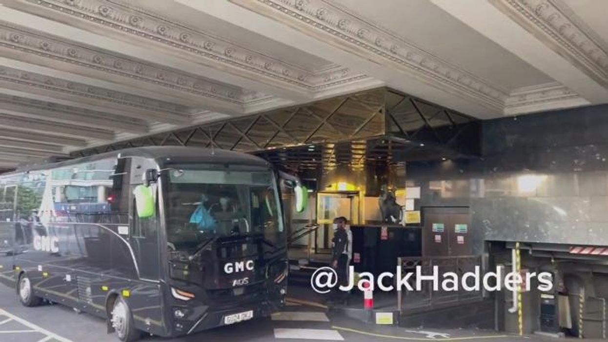 Watch moment coach appears to move migrants from luxury Canary Wharf hotel