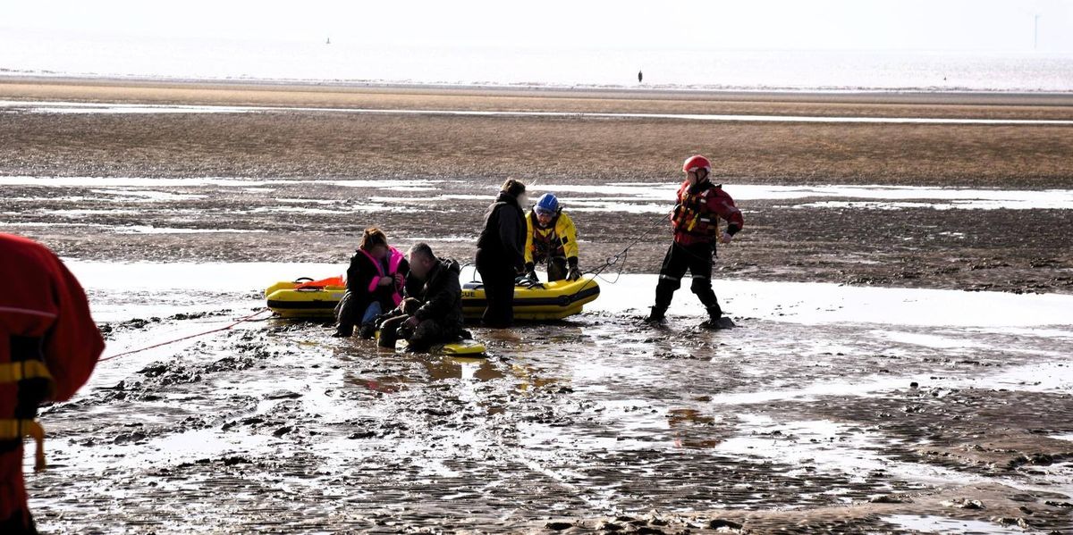 NextImg:Three people and dog saved after getting 'stuck in mud' at popular beach - 'Extremely dangerous!'