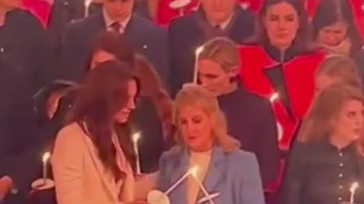 Duchess of Edinburgh struggles to contain giggles as she's greeted by half-naked student