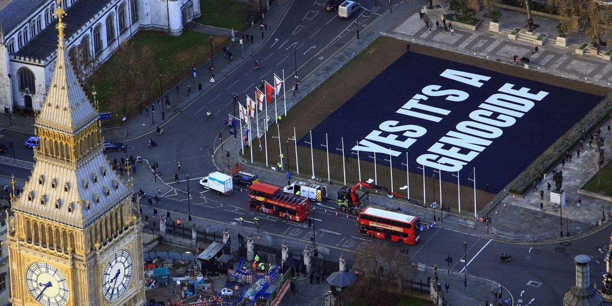NextImg:'Utterly offensive!' Anti-Israel protesters unveil 'genocide' banner outside Parliament