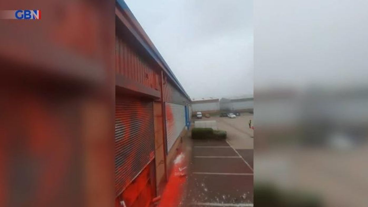 Pro-Palestine activists SMASH lorry into Leicester drone factory before protesters scale roof and set off red flares
