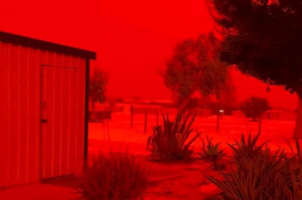 Mediterranean tourist hotspot bathed in blood-red glow as massive dust storm sweeps in