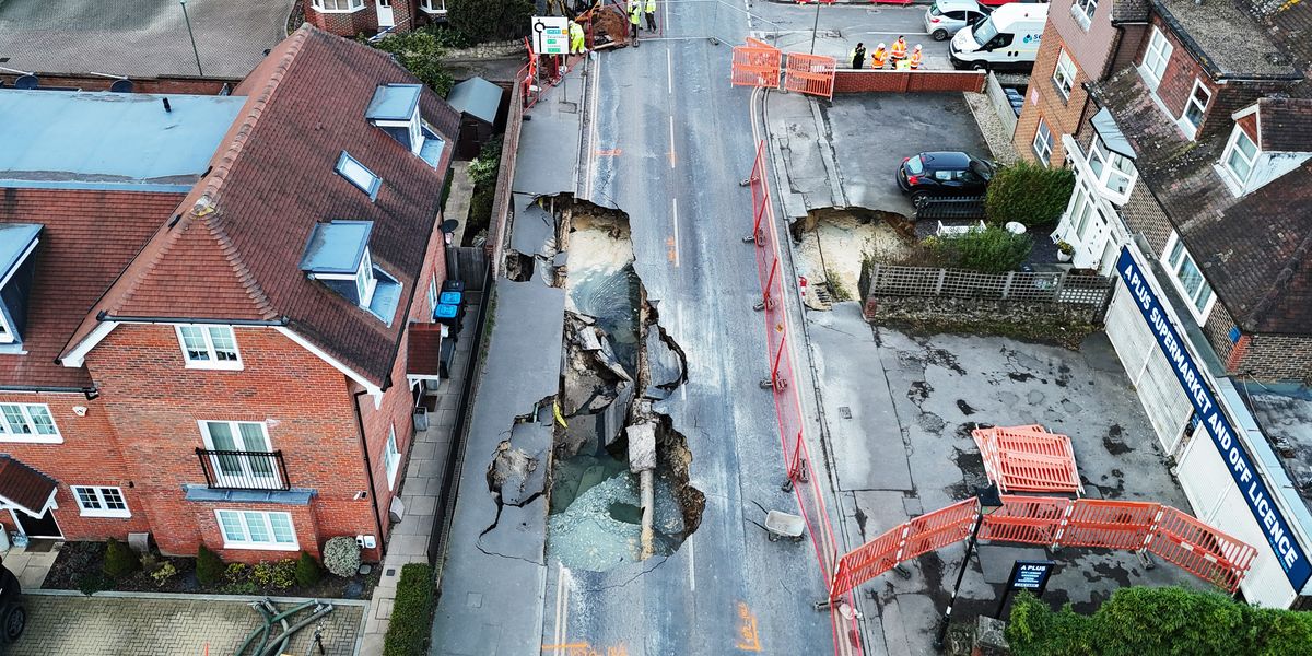 NextImg:Surrey sinkhole: Defiant grandad in row with council workers as he REFUSES to leave home