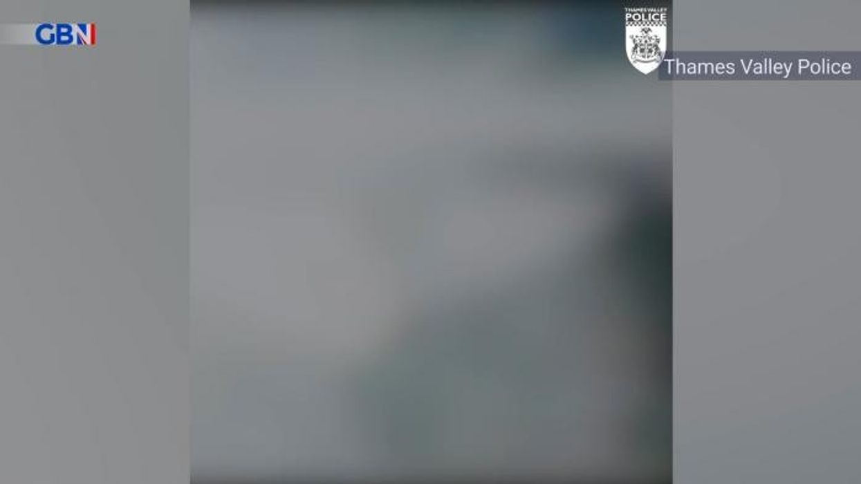 Biker flung over bridge in dramatic footage as two cars crash in head-on collision