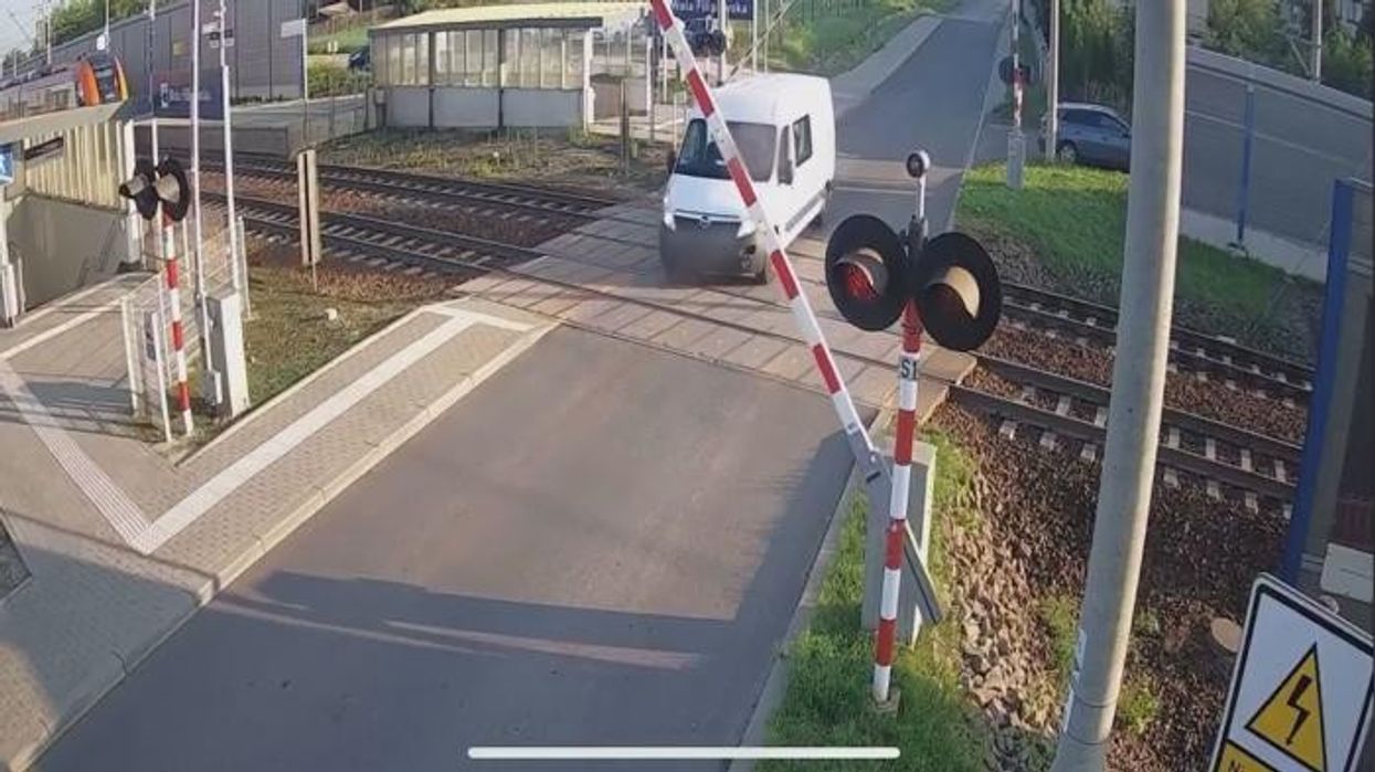 Watch the moment van is DESTROYED by train after driver tried to skip barriers at level crossing