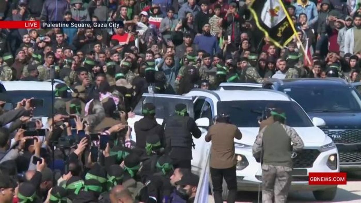 Crowds in Israel erupt in cheers as four hostages released while Hamas gunmen stand watch