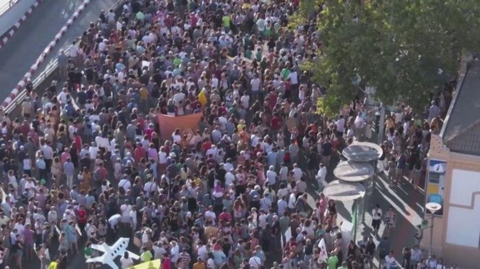 Tourist dead and nine injured after powerful wave drags swimmers out to sea at popular holiday hotspot