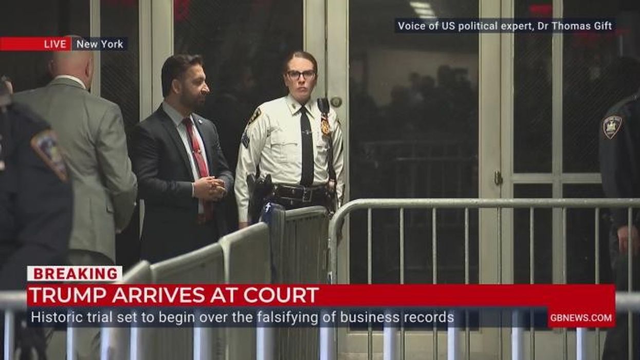 Donald Trump takes PHONE CALL from inside court as trial begins