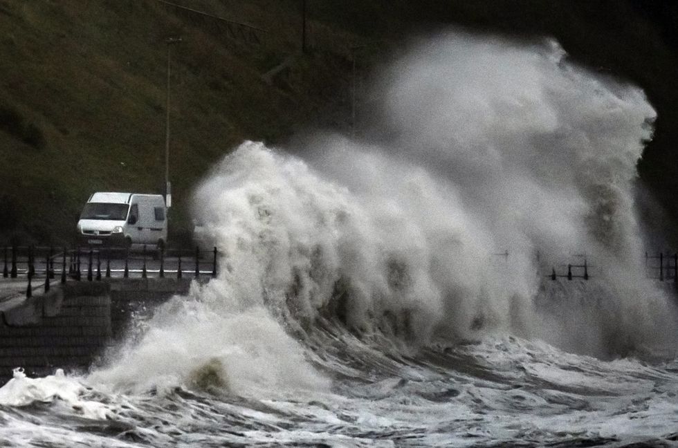 Waves crash over the promenade in Scarborough, as Storm Babet batters the country