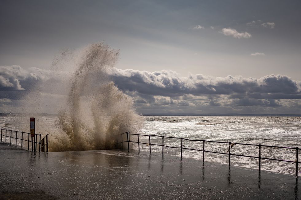 Waves whipped up by the wind hit Crosby Beach promenade as Storm Lilian brings rain and high winds to the UK