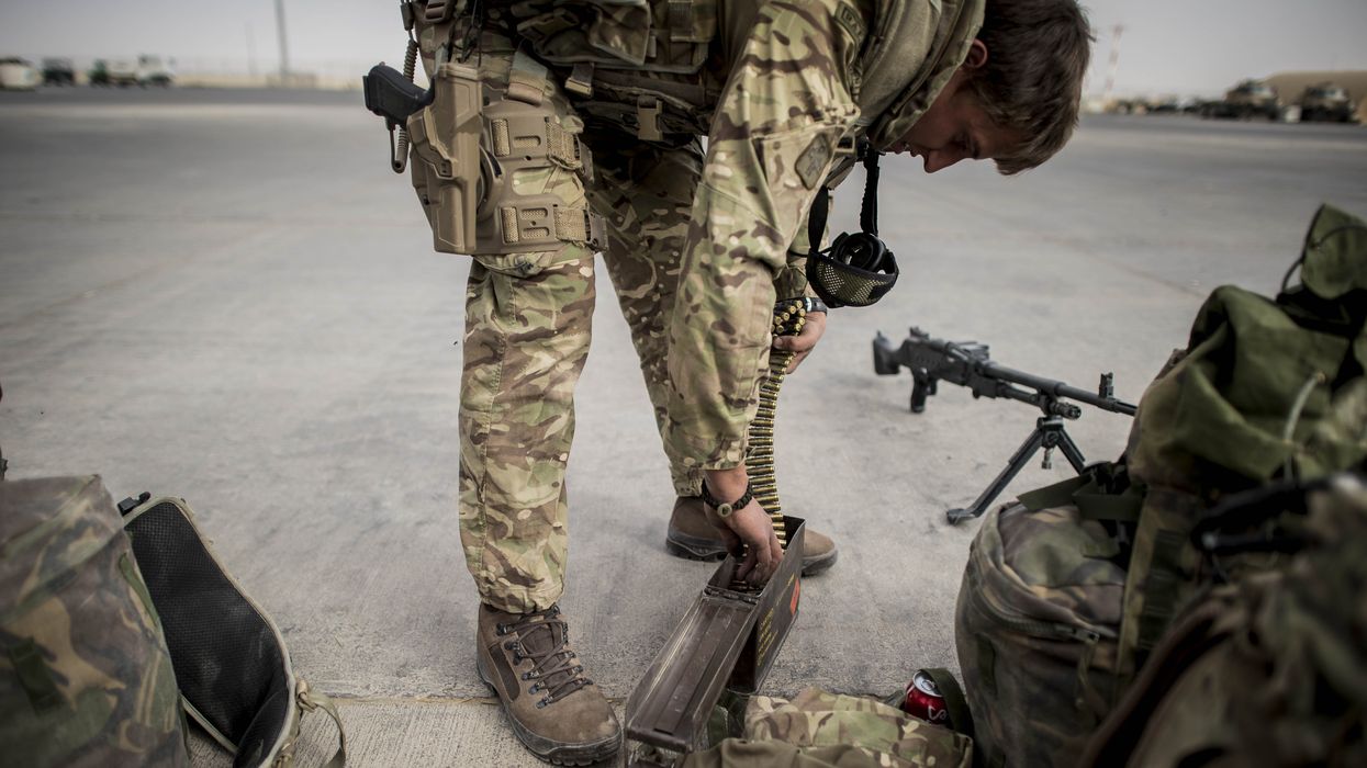 Weapons and ammunition are checked as some of the last British troops head towards the flight line as they prepare to leave Camp Bastion, Helmand Province