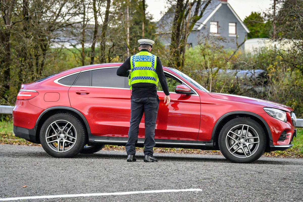 Welsh police pull over cars at a checkpoint during firebrake vehicle patrols close to the border between Carmarthenshire and Pembrokeshire