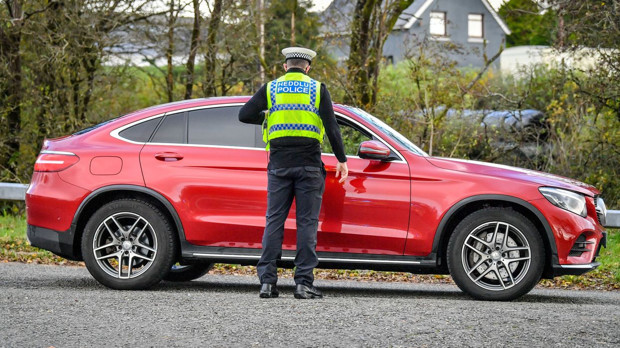 Welsh police pull over cars at a checkpoint during firebrake vehicle patrols close to the border between Carmarthenshire and Pembrokeshire