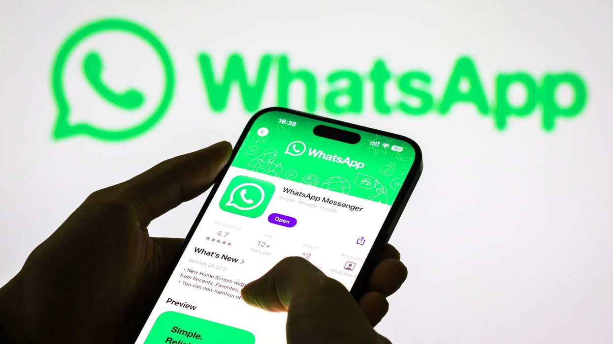 WhatsApp listing in the app store shown on an iphone screen with the whatsapp logo in the background