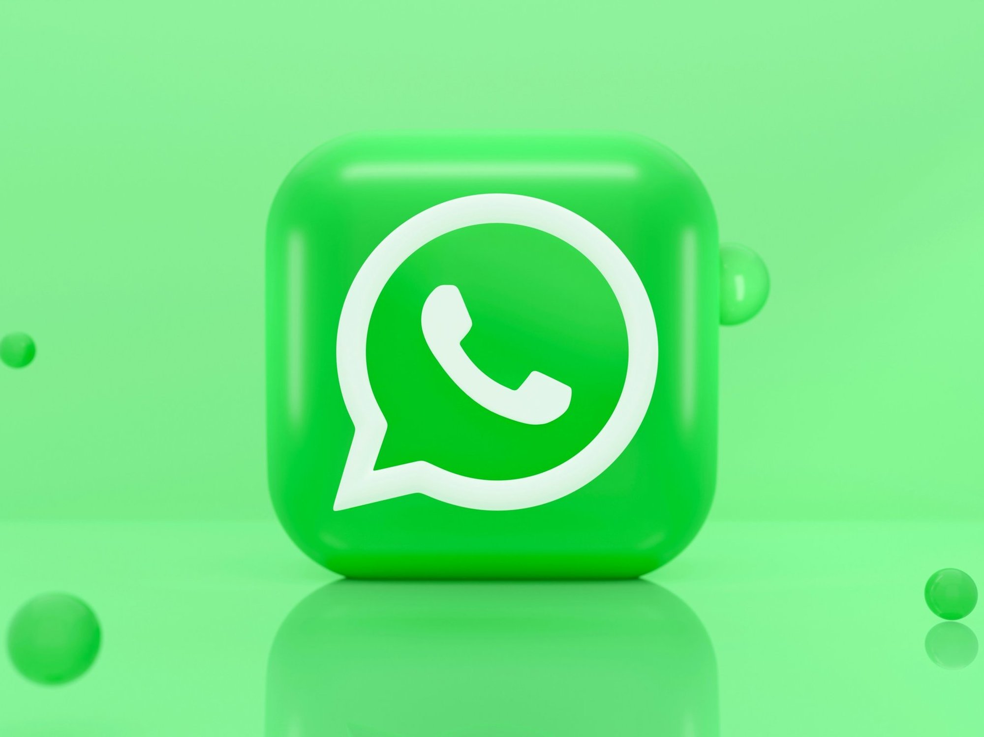 WhatsApp logo in front of green background
