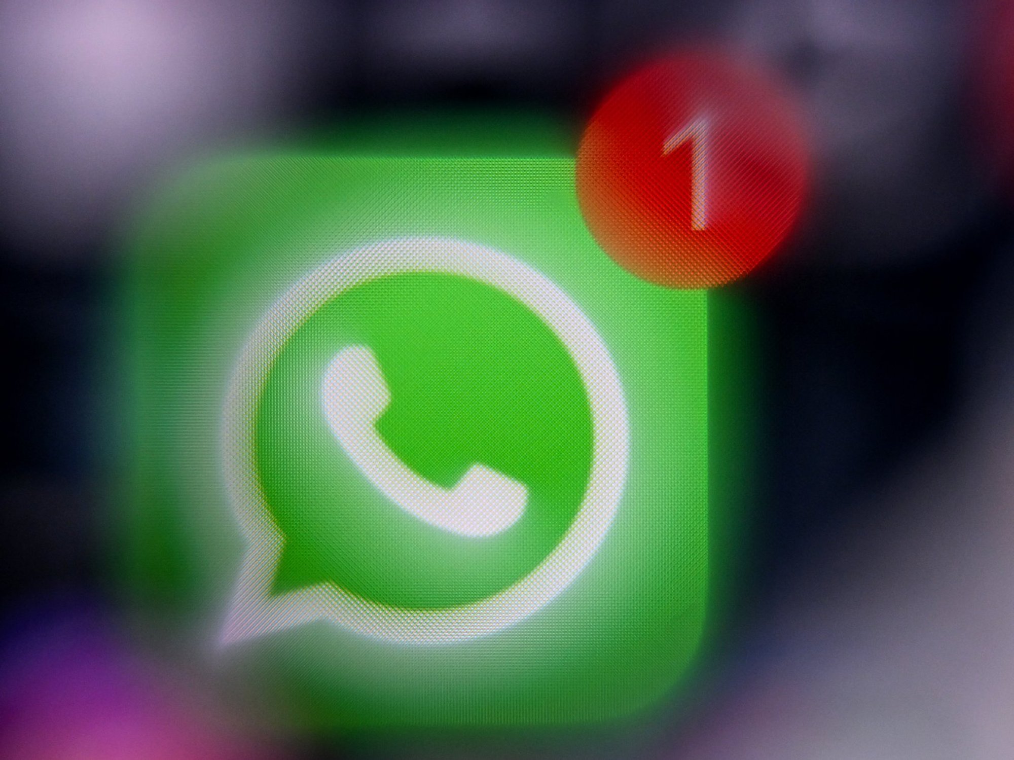 WhatsApp logo on mobile with 1 unread message