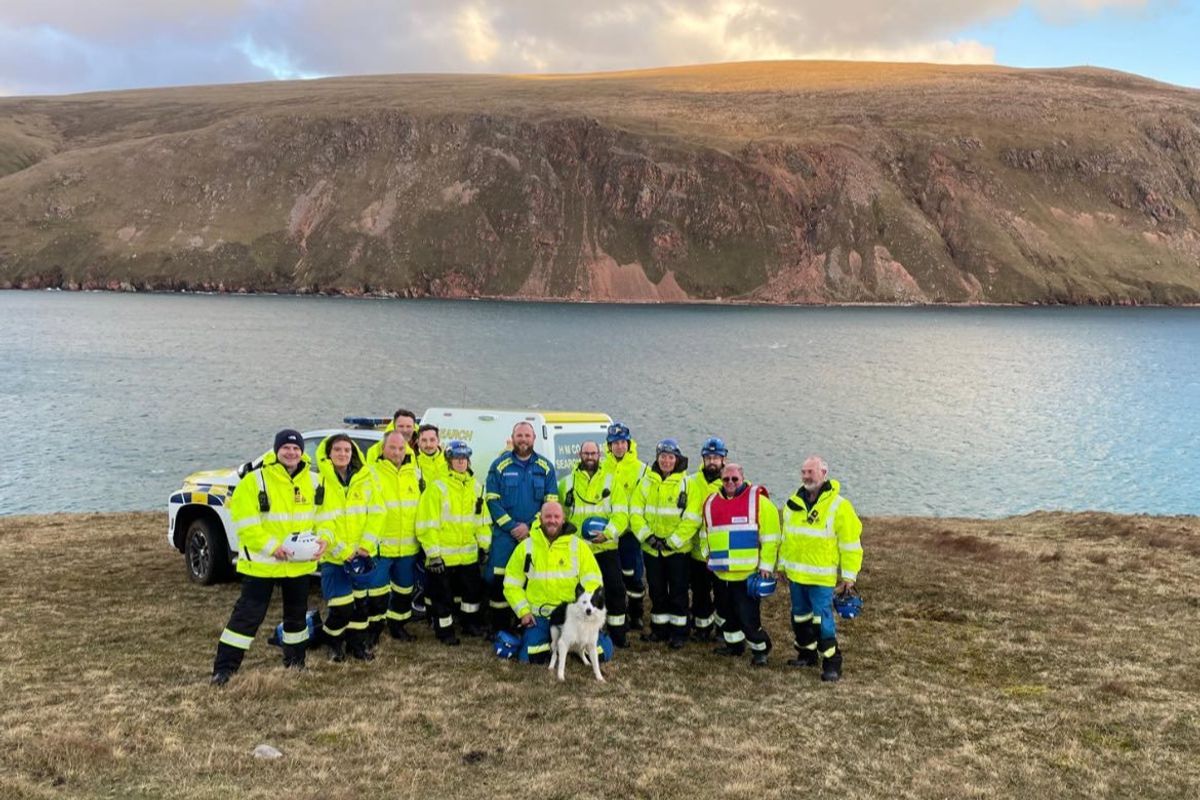 Whisp the dog with his coastguard rescuers