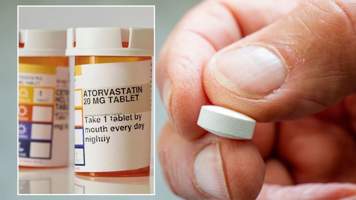 WHITE PILL IN HAND AND STATIN STOCK IMAGE