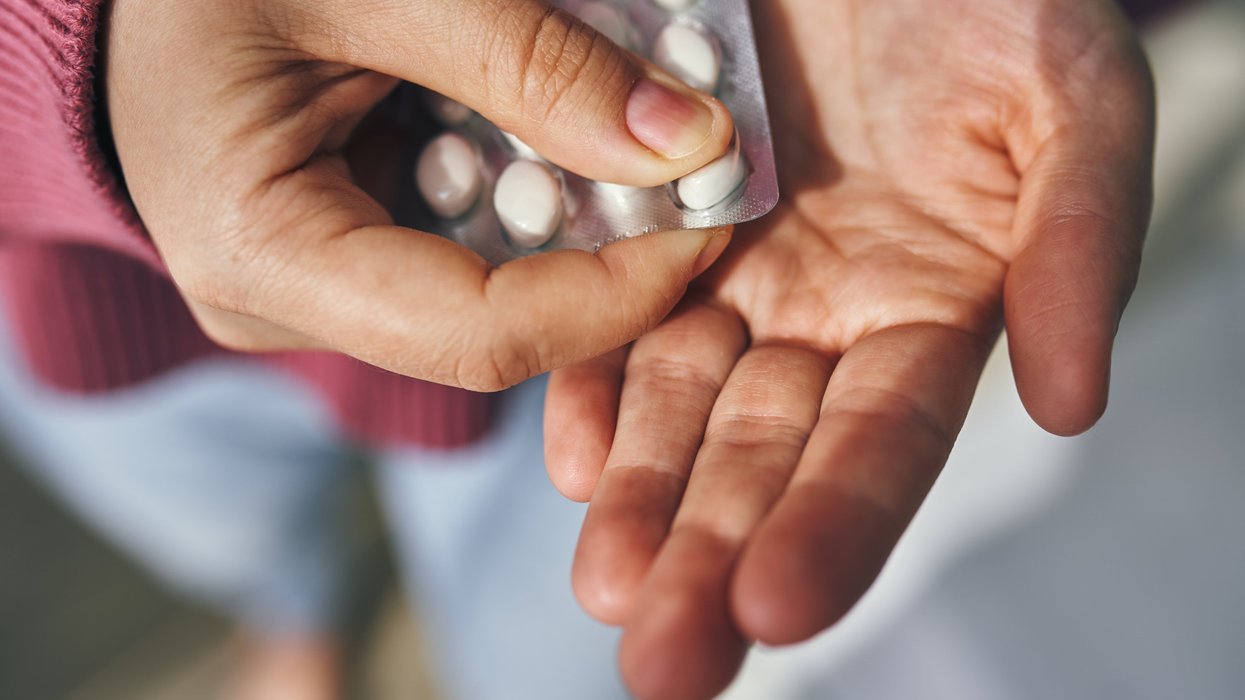 White pills and hand