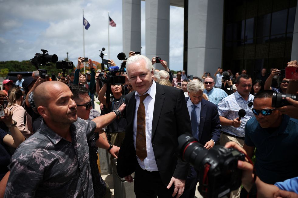 WikiLeaks founder Julian Assange makes his way as he leaves the United States District Court