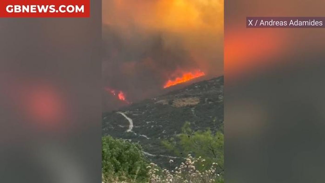 At least two people dead as wildfires ravage popular European hotspot with Britons issued urgent travel alert