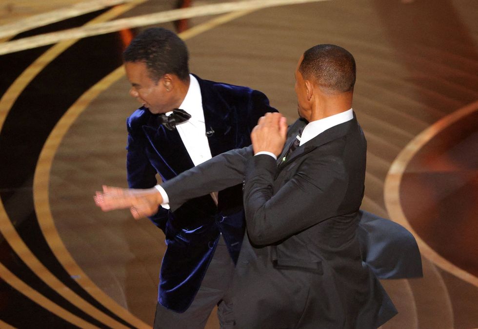 Will Smith hits at Chris Rock as Rock spoke on stage during the 94th Academy Awards in Hollywood, Los Angeles, California, U.S., March 27, 2022.