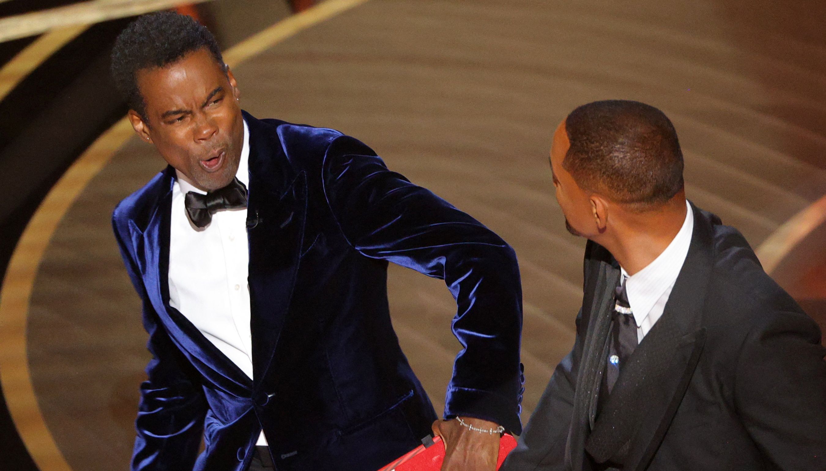 Will Smith (R) hits at Chris Rock as Rock spoke on stage during the 94th Academy Awards in Hollywood, Los Angeles, California, U.S.