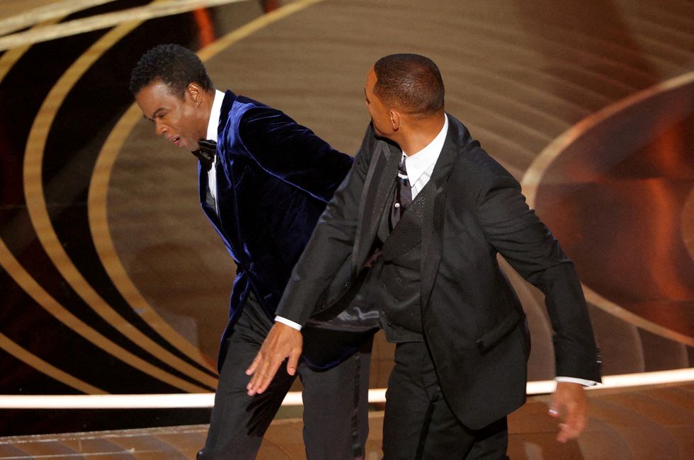Will Smith (R) slaps Chris Rock