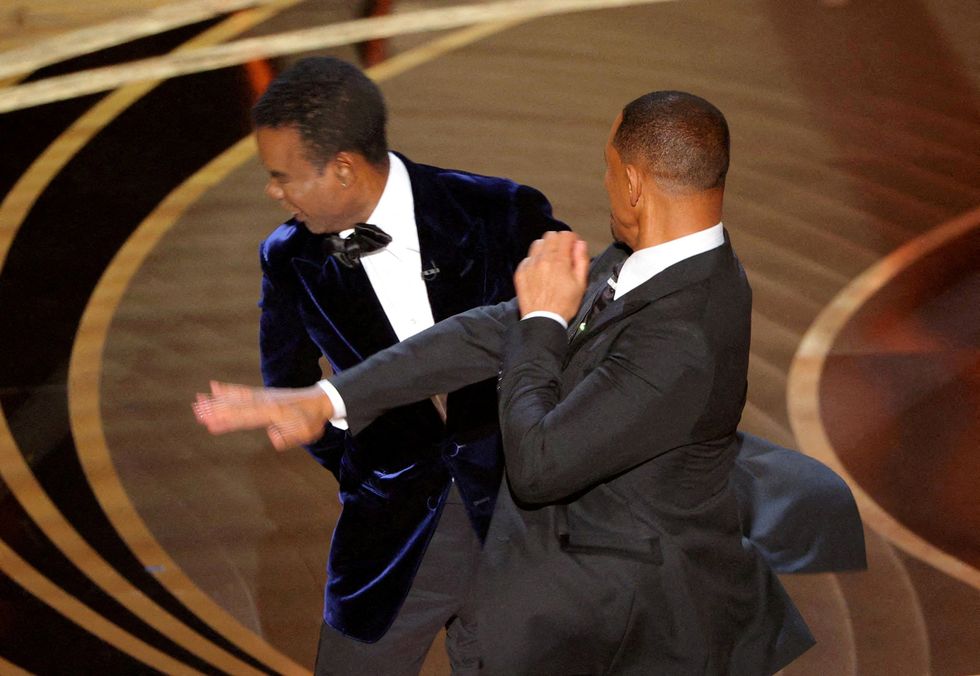 Will Smith slaps Chris Rock across the face at the 2022 Oscars