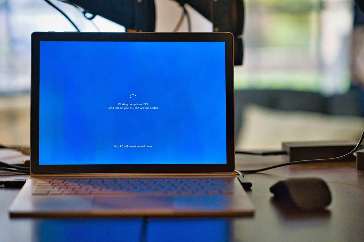 Windows 10 laptop pictured on a desk performing a Windows 10 update
