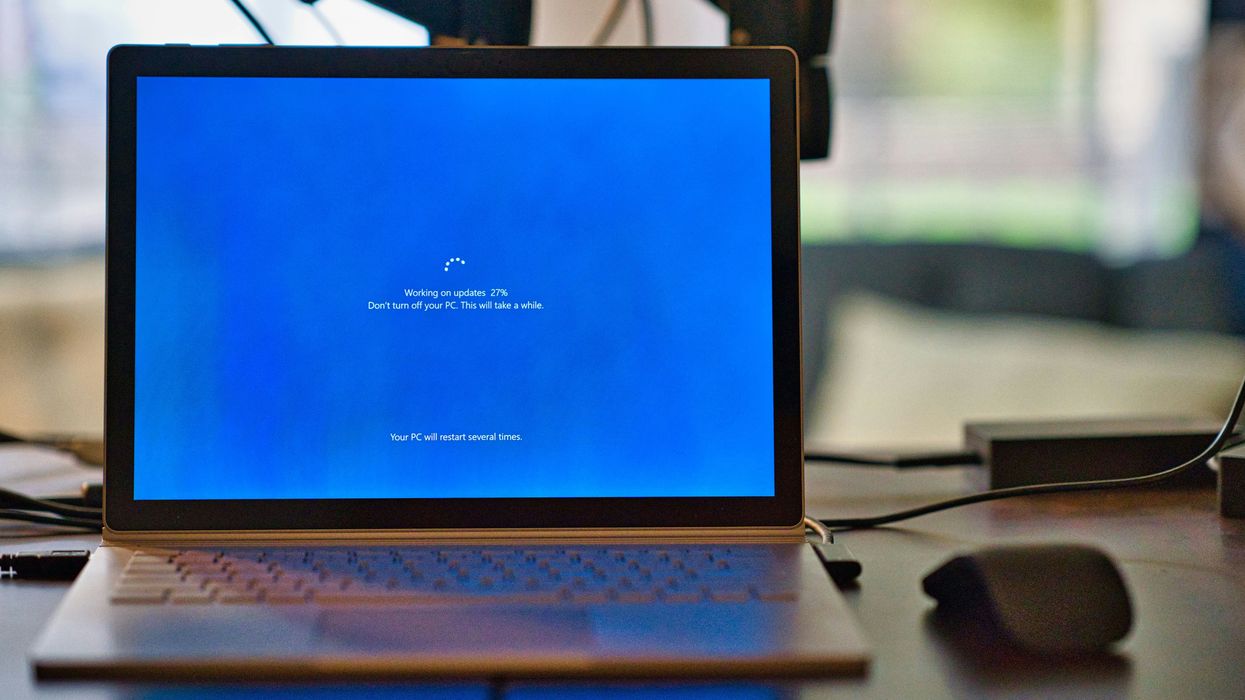 Windows 10 laptop pictured on a desk performing a Windows 10 update