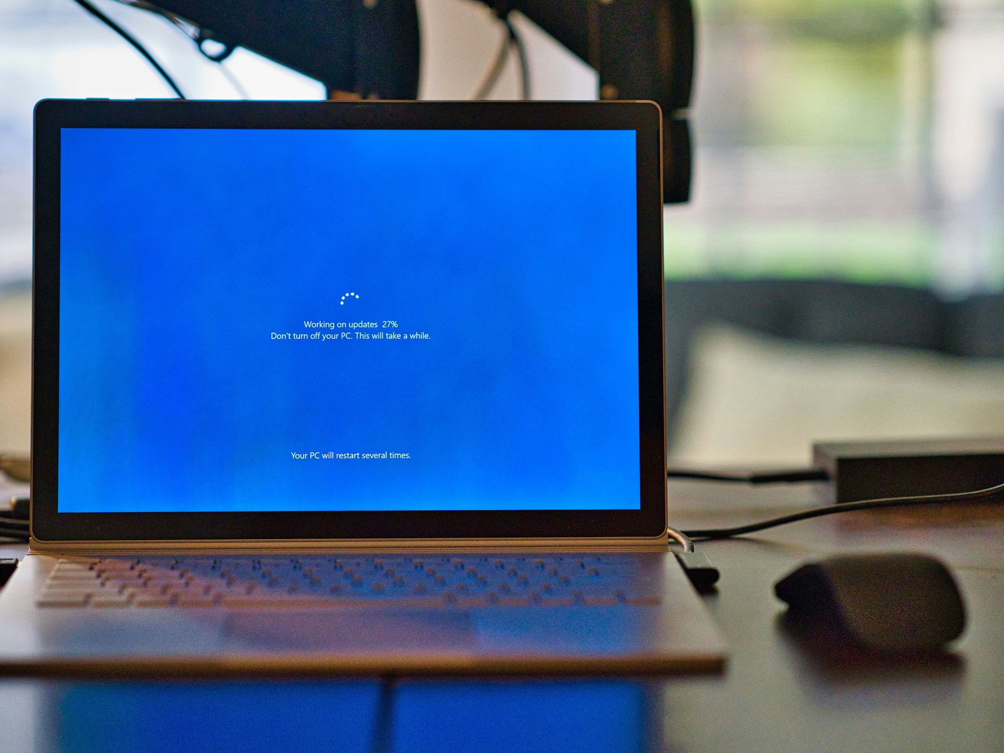 Windows 10 laptop pictured on a desk performing a Windows 10 update