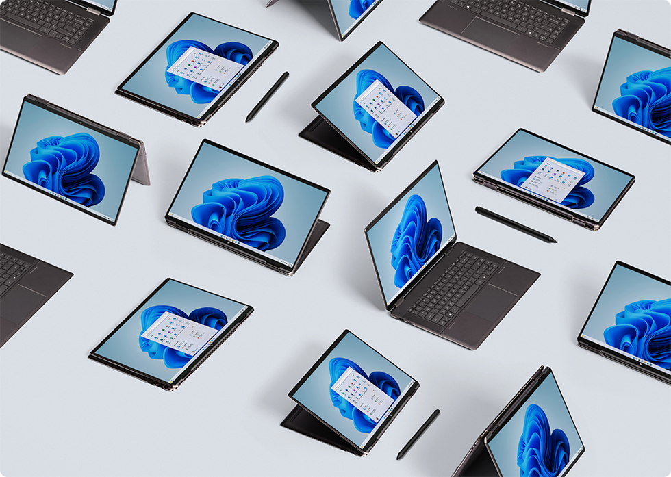 windows 10 laptops and tablet combos pictured arranged on the ground