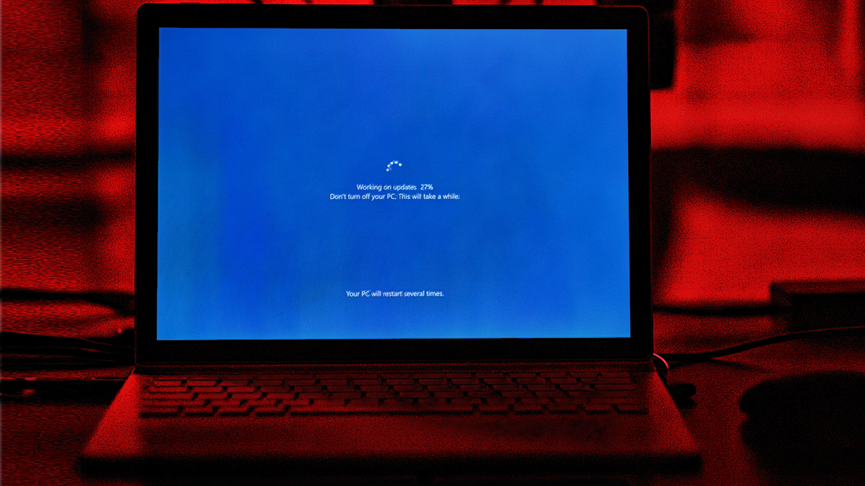 Windows 10 PC with the Windows Update screen showing progress on-screen