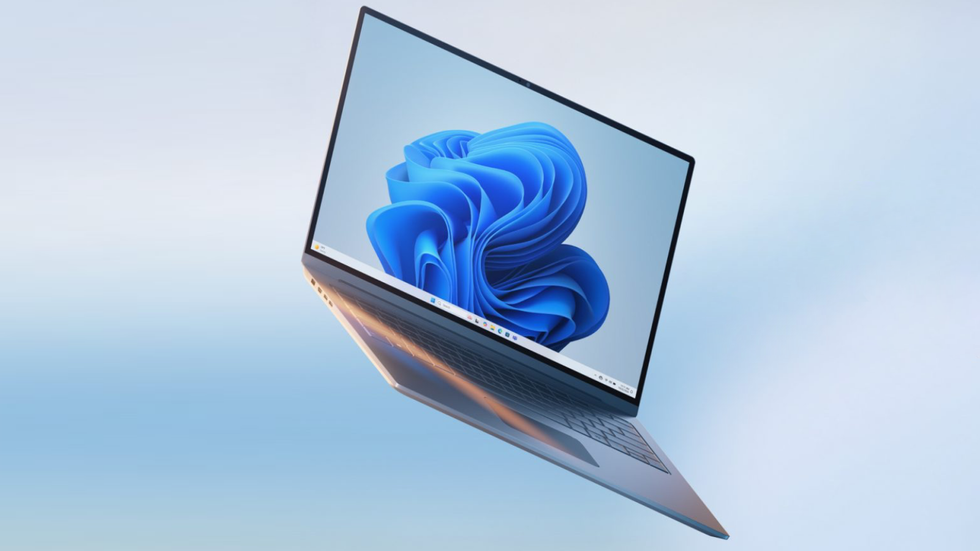 Windows 11 laptop pictured on a light blue background 