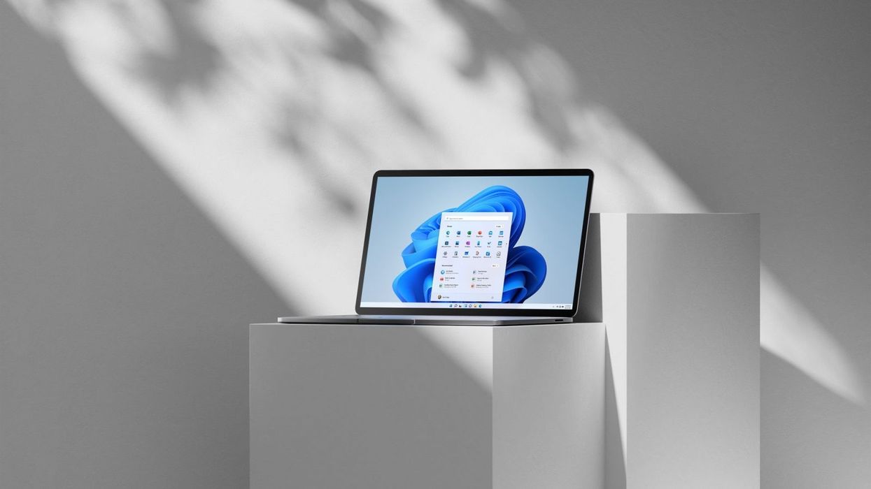windows 11 operating system shown on a laptop on a grey plinth