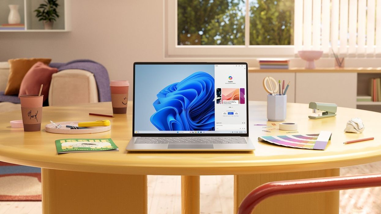 windows 11 running in a laptop on a busy table