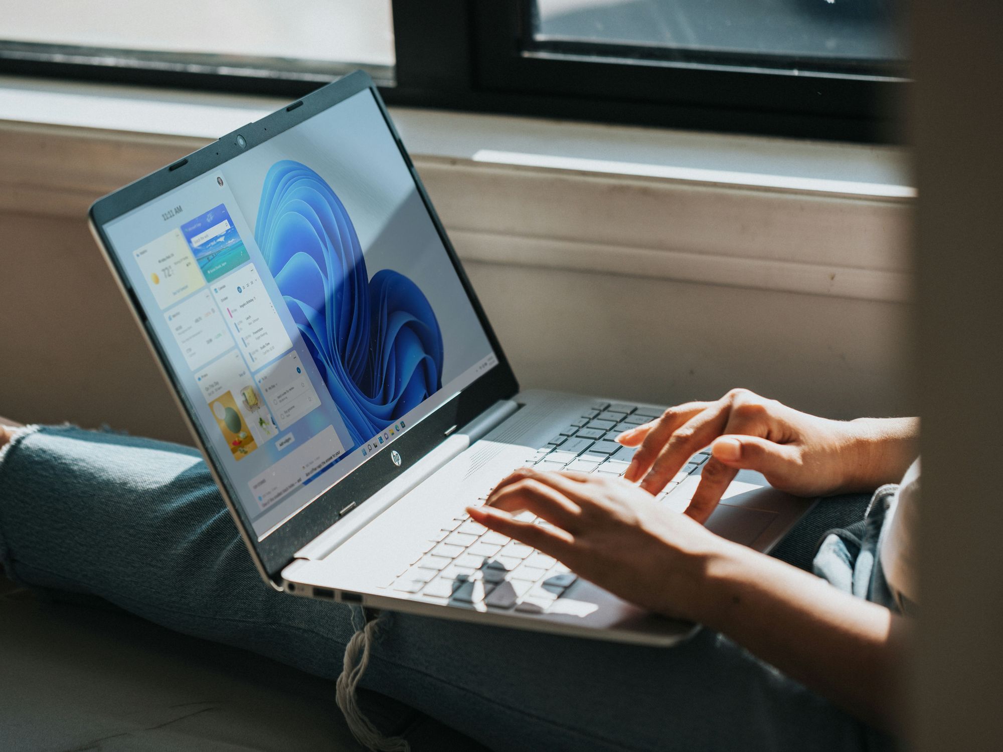 Windows 11 showing on a laptop while someone works