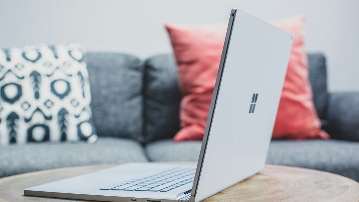 windows logo on a laptop sit on a wooden table