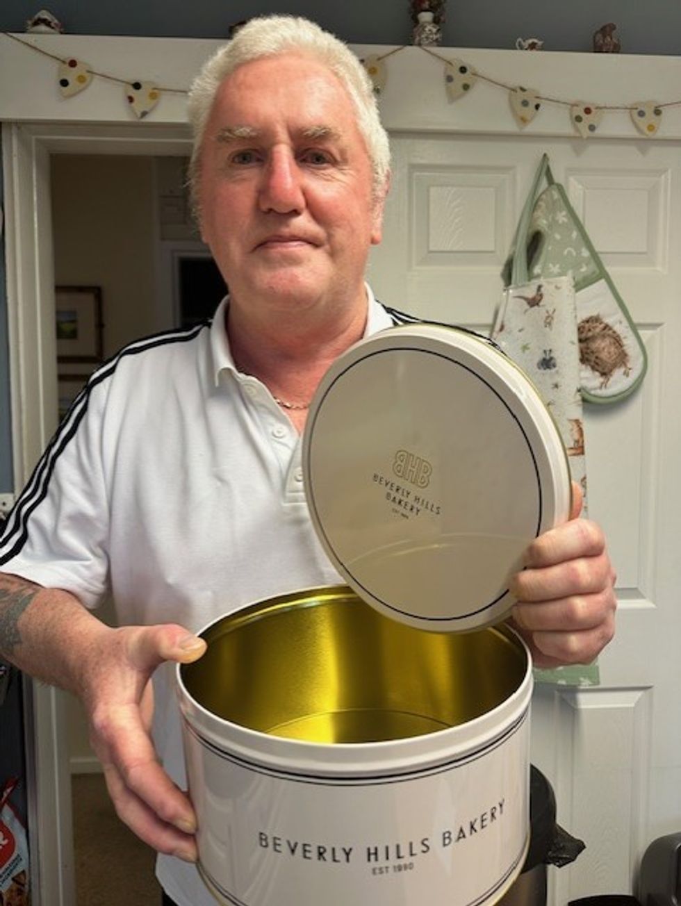 Winner Les from Staffordshire with his tin of baked goods.