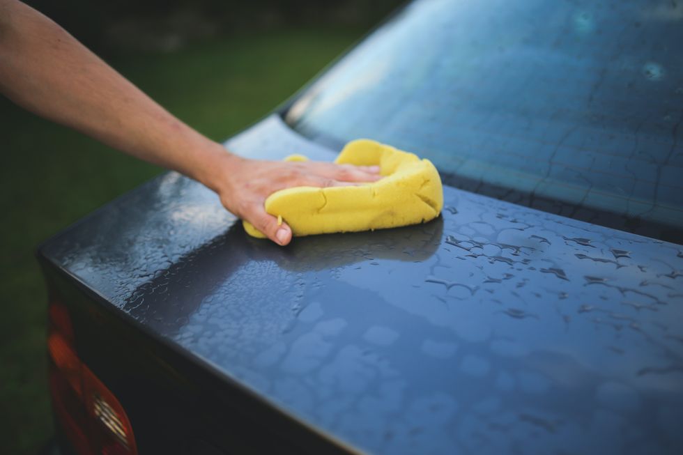 Wiping a car with a cloth