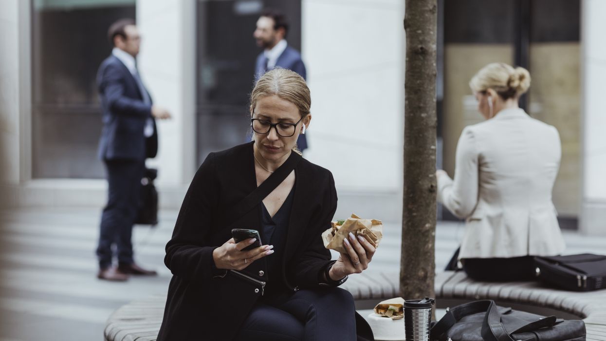 Woman answers messages while having lunch break