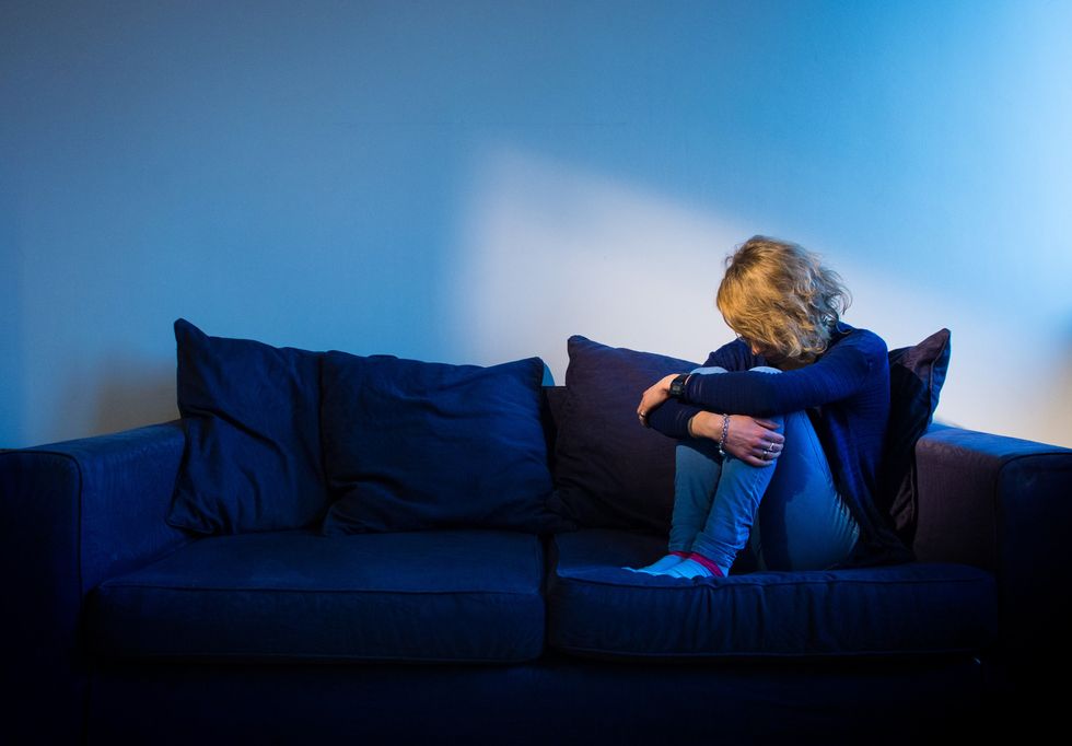 Woman appears depressed on sofa