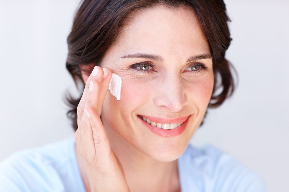 Woman applying eye cream