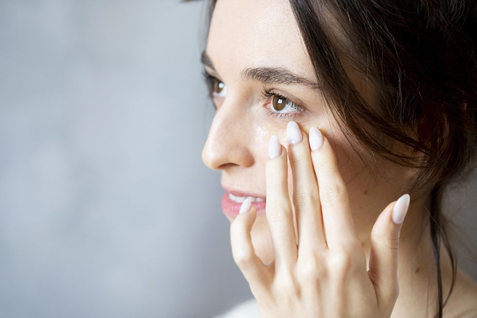 Woman applying eye cream