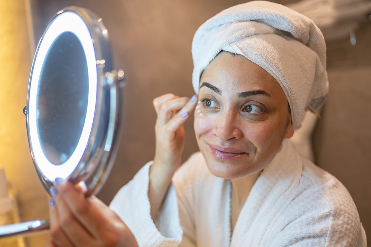 Woman applying eye cream