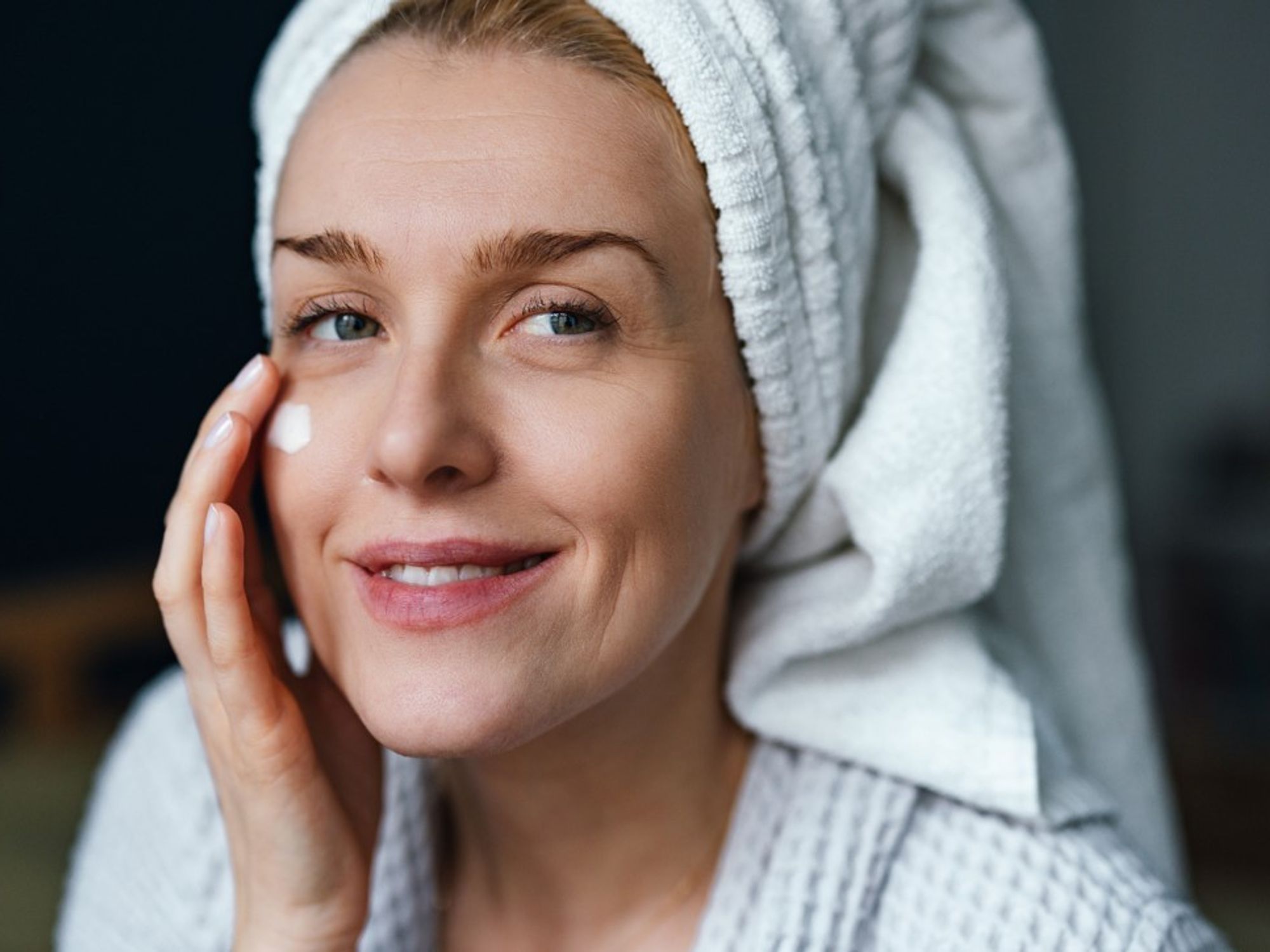 Woman applying eye cream