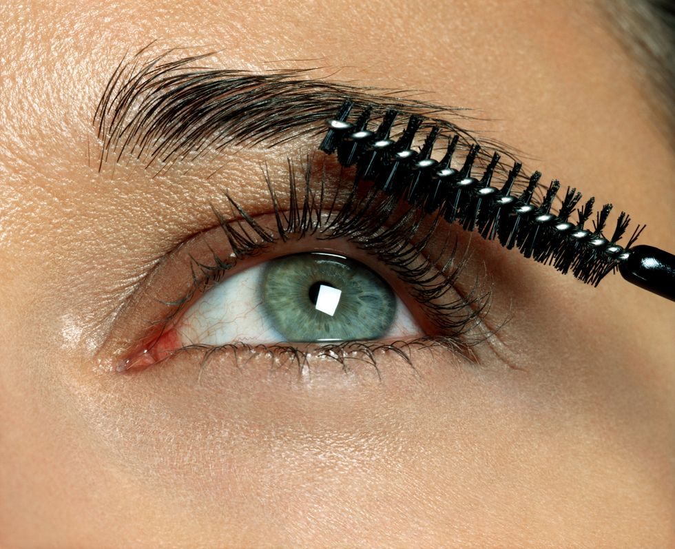 Woman applying eye makeup